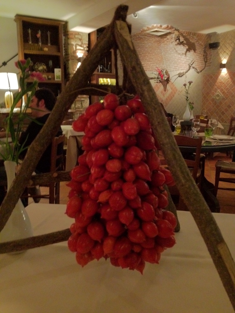 Pienolo DOP tomatoes on display on a local Vesuvian trattoria; it shows the way the tomatoes are placed on stalks for their cultivation and after harvest they need to be maintained on the same way for better conservation, this is according to an ancient tradition in Campania.  